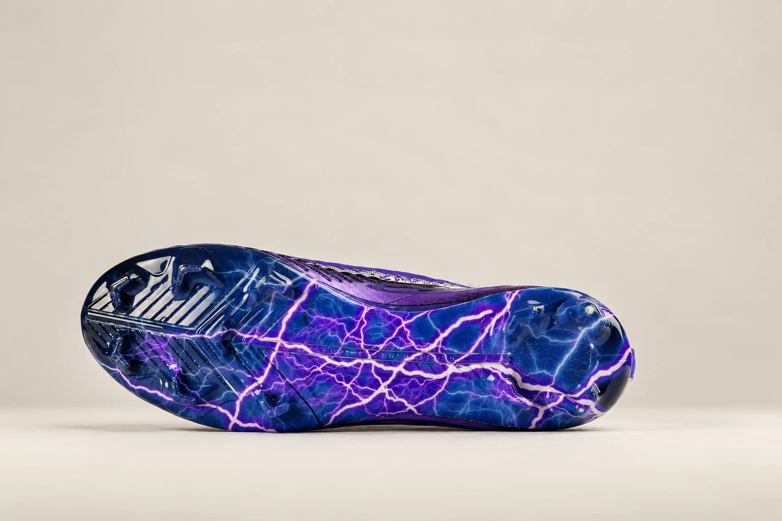 The Stravion lightning-print TPU outsole and stud layout.